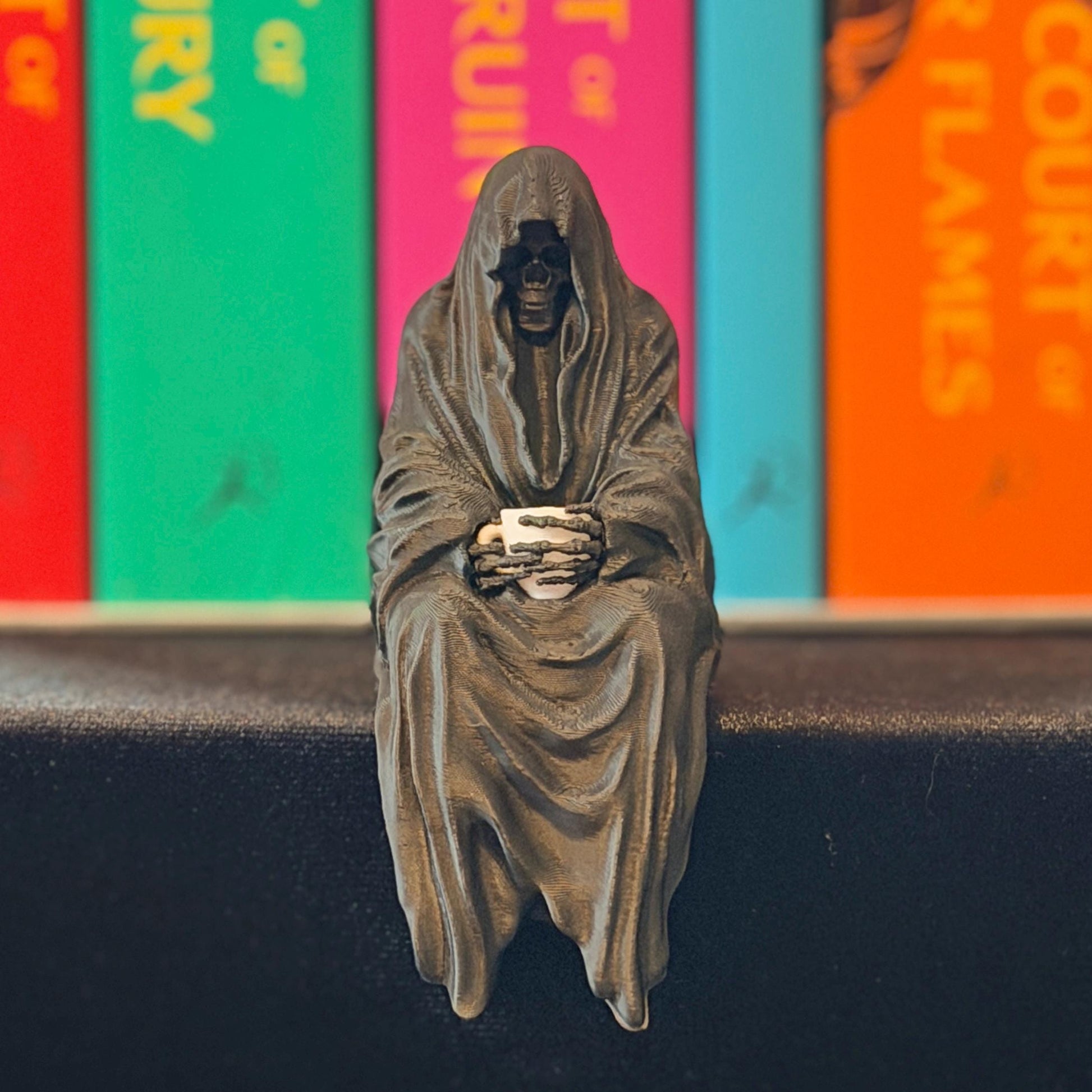 ACOTAR inspired Suriel with tea mug 3d printed shelf sitter, as seen in black and white color option.