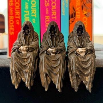 ACOTAR inspired Suriel with tea mug 3d printed shelf sitter, as seen in three different color options.